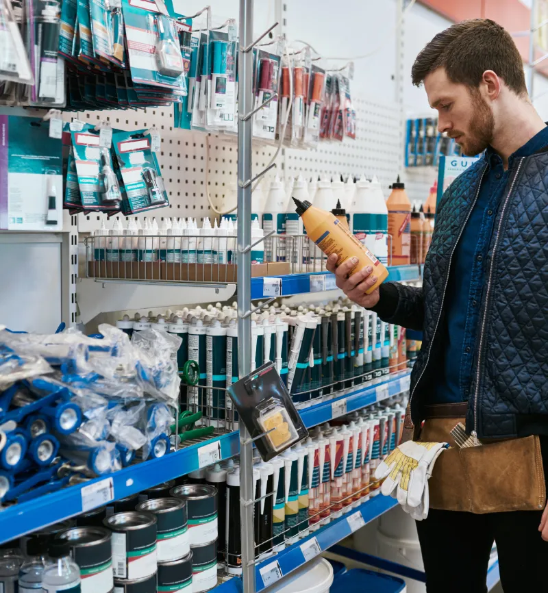 Man holding a home improvement product in an aisle