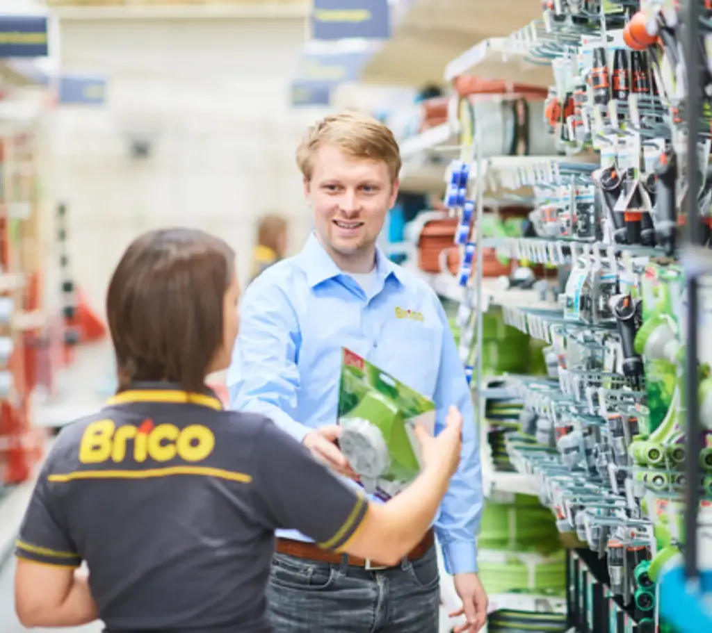 A Brico team member helping a customer find an item